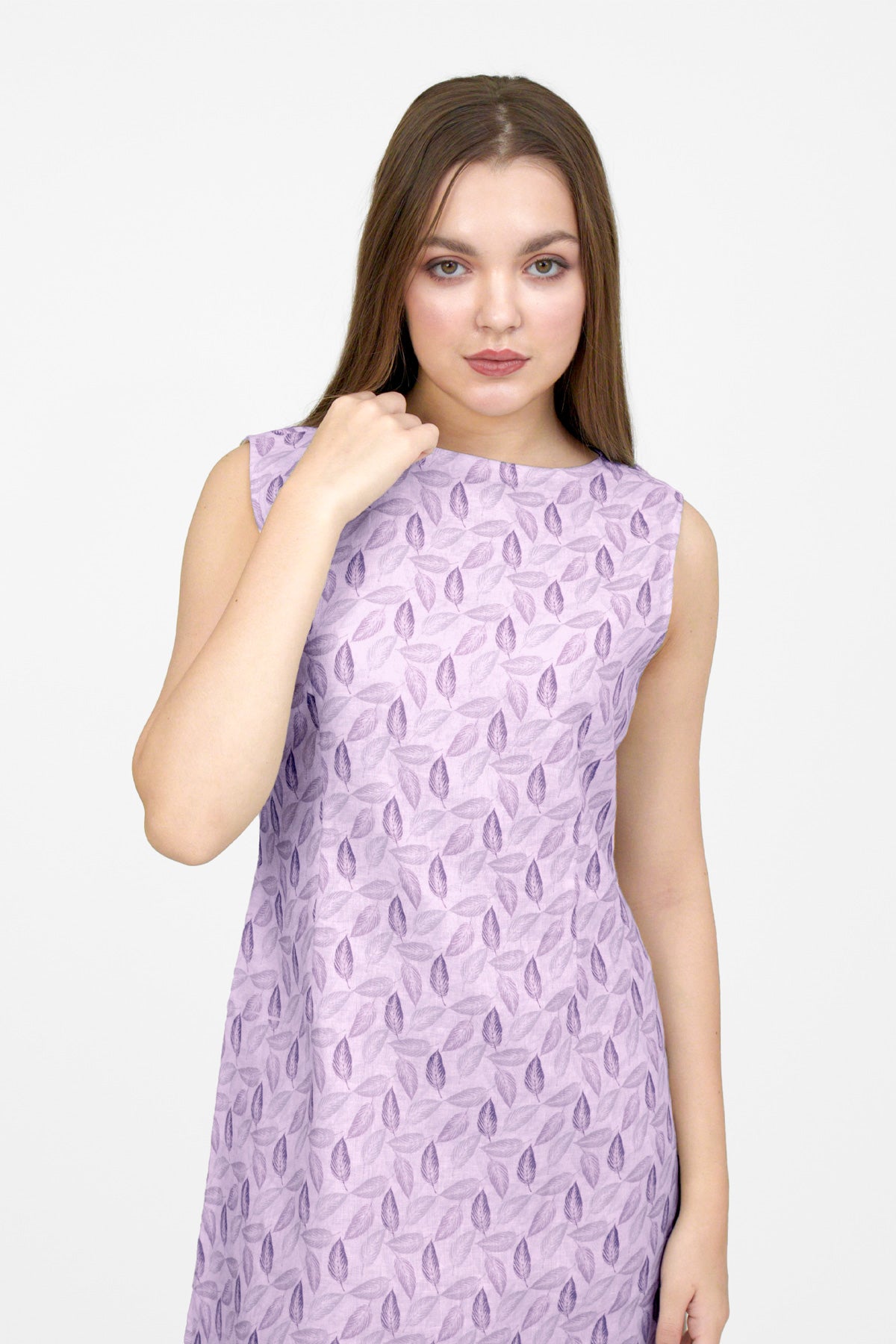 Woman wearing a purple patterned dress on a white background