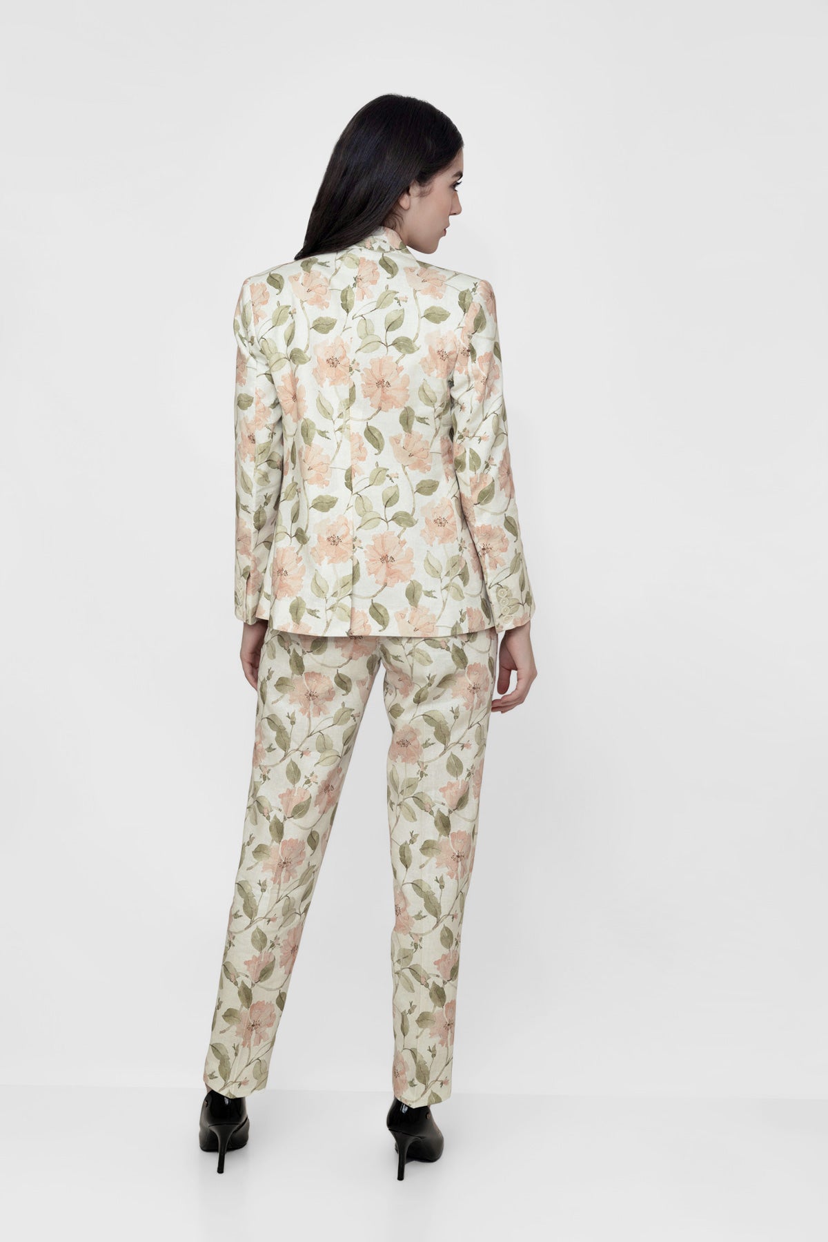 Woman wearing a floral suit on a white background