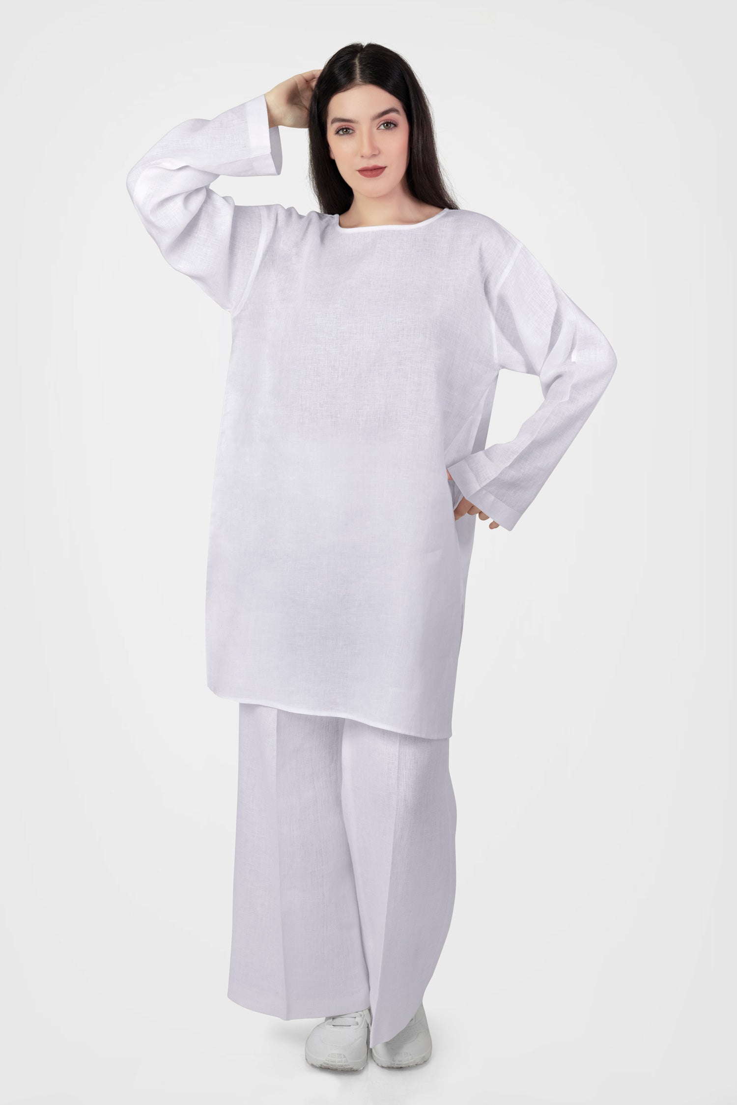Women wearing white long top with long sleeves near beach