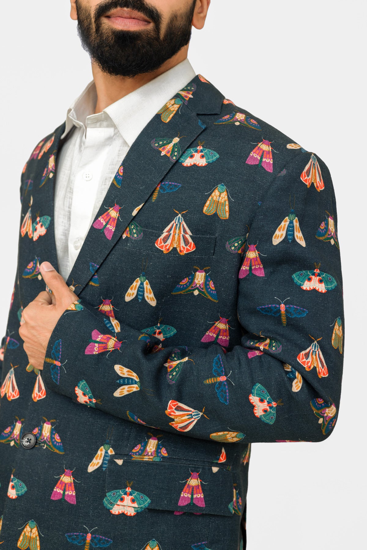 Man wearing a butterfly printed blazer on a white background