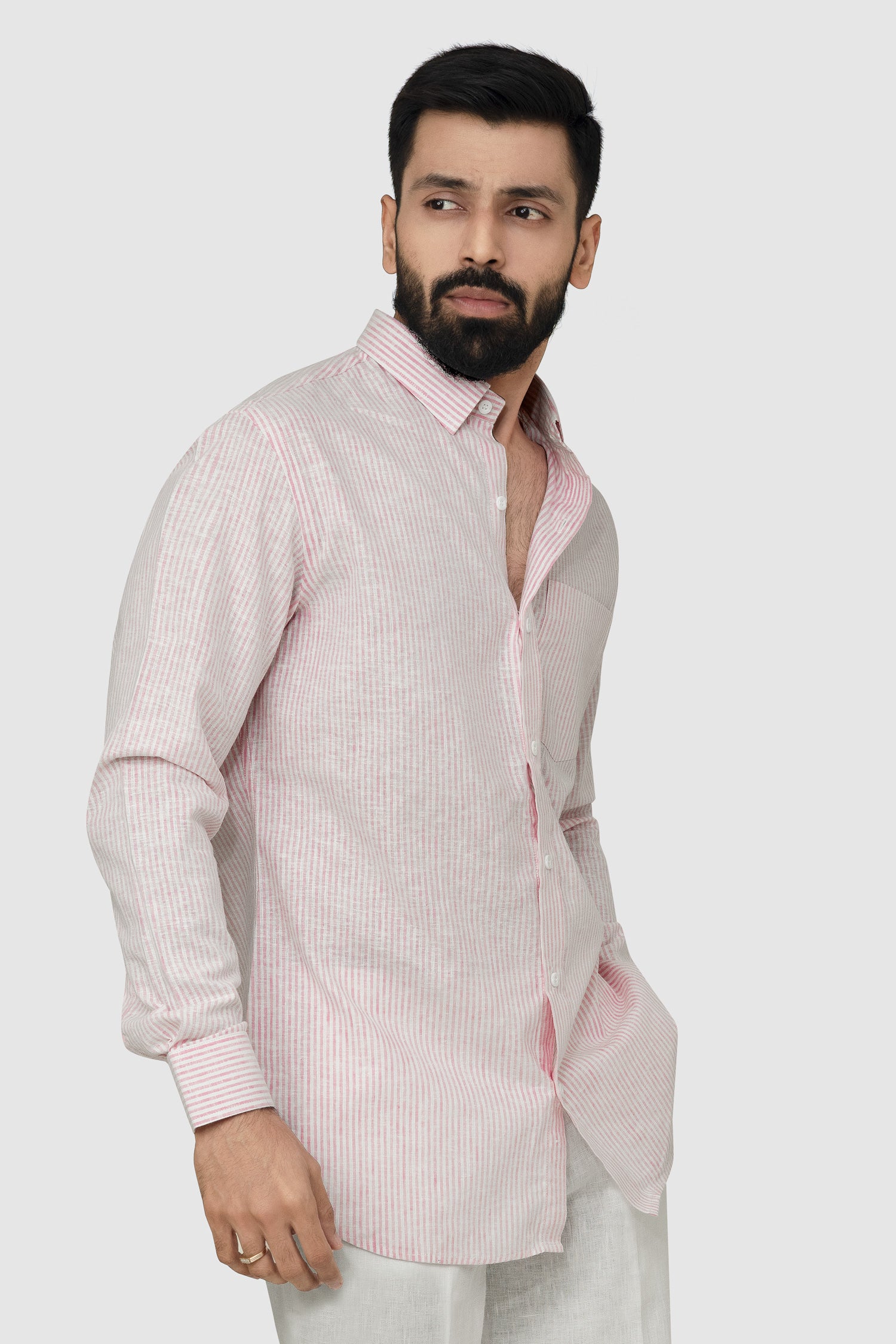Man wearing a pink striped shirt against a plain background