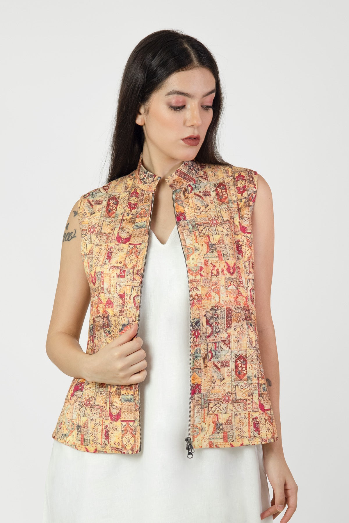 Woman wearing a patterned vest on a white background