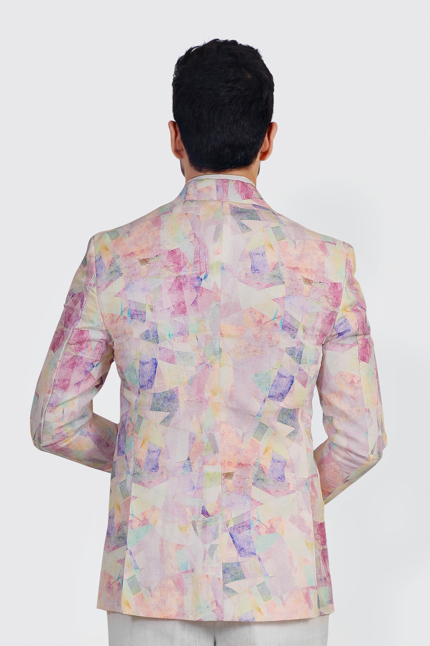 Pastel floral patterned jacket worn by a person on a white background