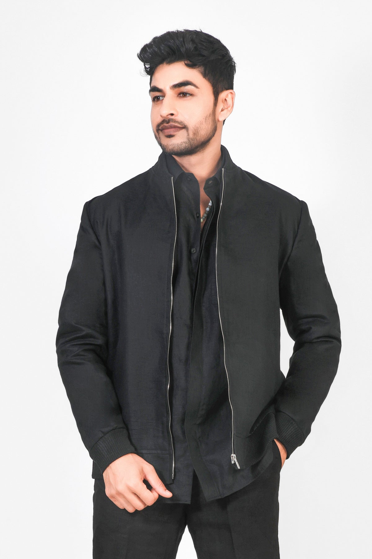 Man wearing a black jacket on a white background