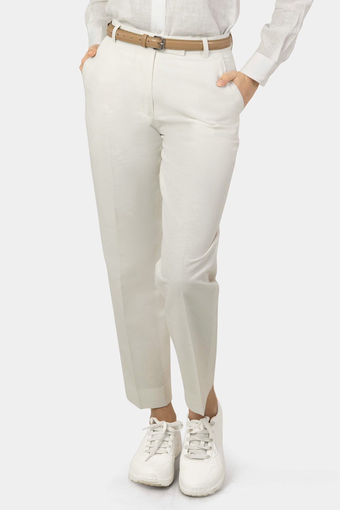 A pair of white women's hemp trousers with a belt, slanting front pockets, and jetted back pockets, featuring a hook and bar closure at the waistband and a zip fly.