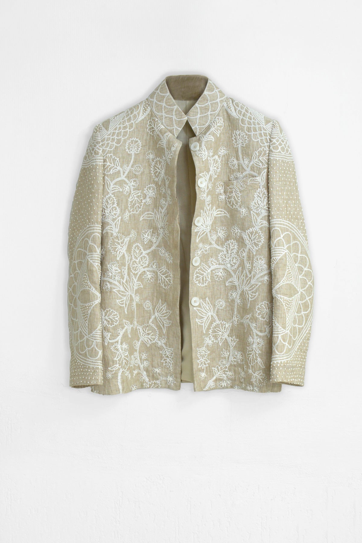 Beige floral-patterned coat on a white background