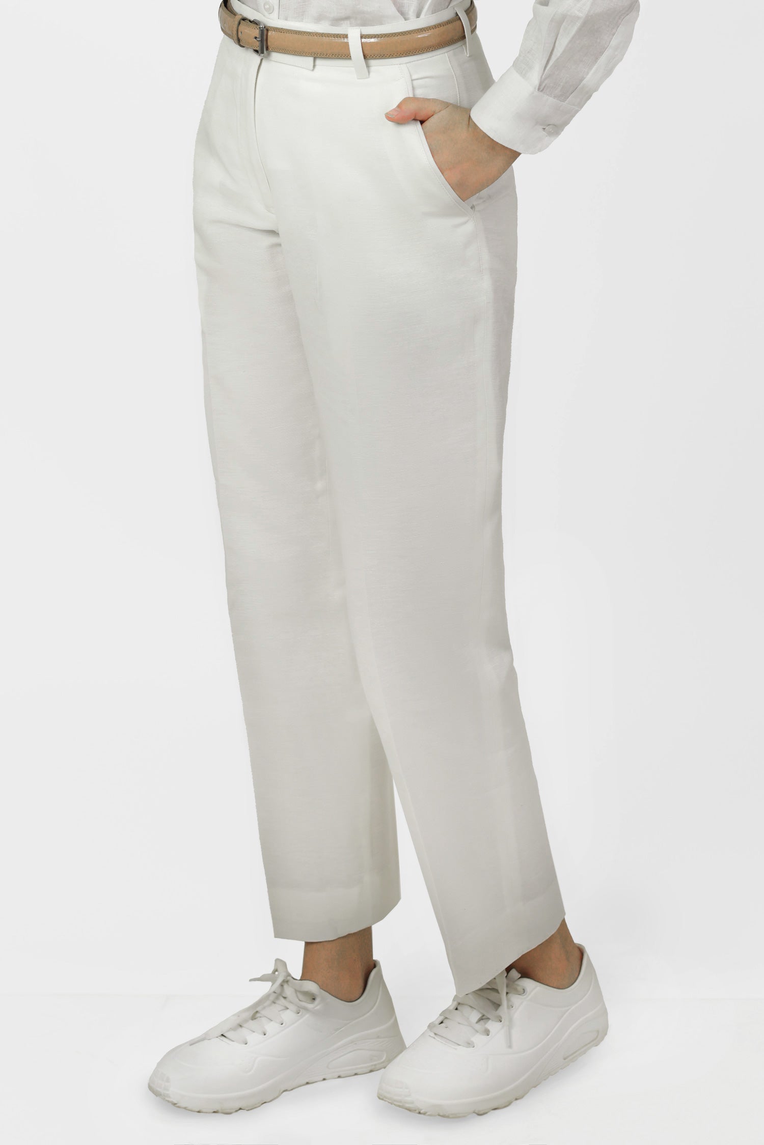 A pair of white women's hemp trousers with a belt, slanting front pockets, and jetted back pockets, featuring a hook and bar closure at the waistband and a zip fly.