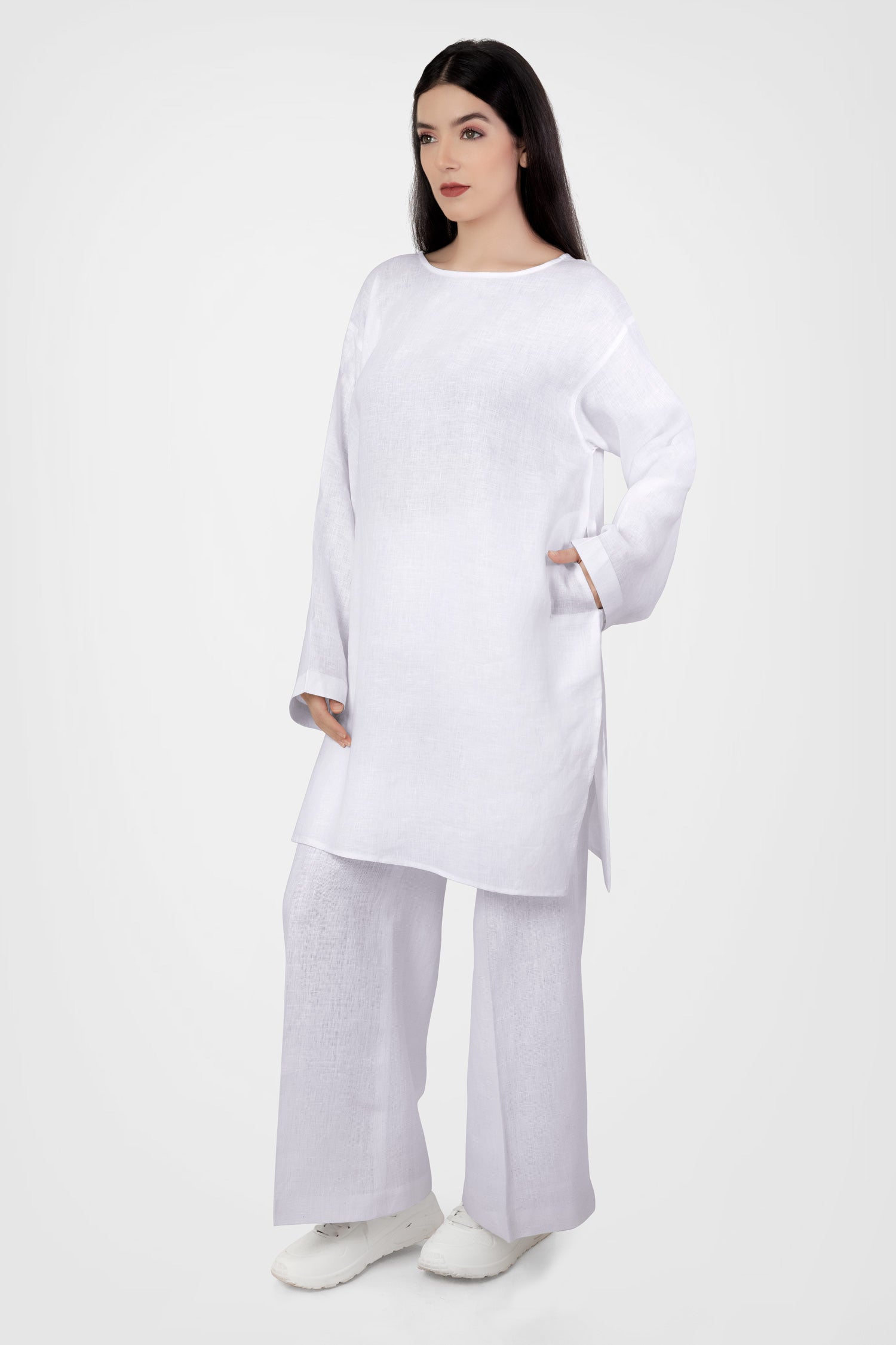 Women wearing white long top with long sleeves near beach