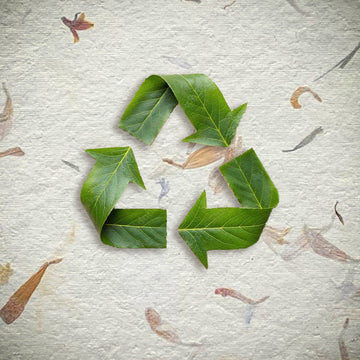 Three green leaves arranged into the recycling symbol