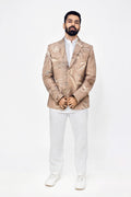 Man wearing a beige Eco-printed blazer over a white shirt and pants on a white background