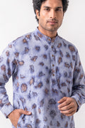 A man wearing a light blue-gray long-sleeve kurta with a brown and beige tie-dye pattern, photographed against a plain light background.