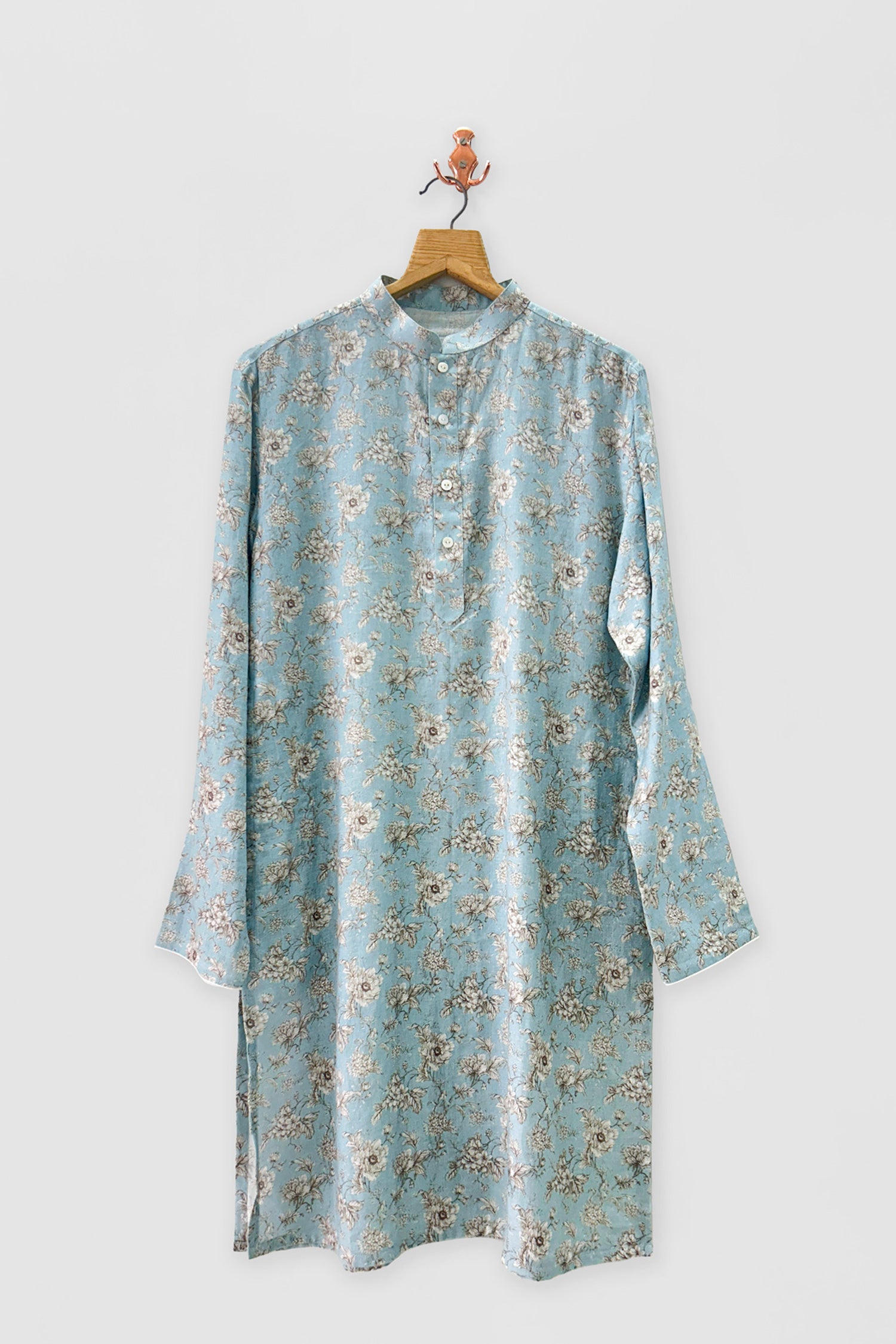 Light blue floral Shirt on a hanger against a light gray background