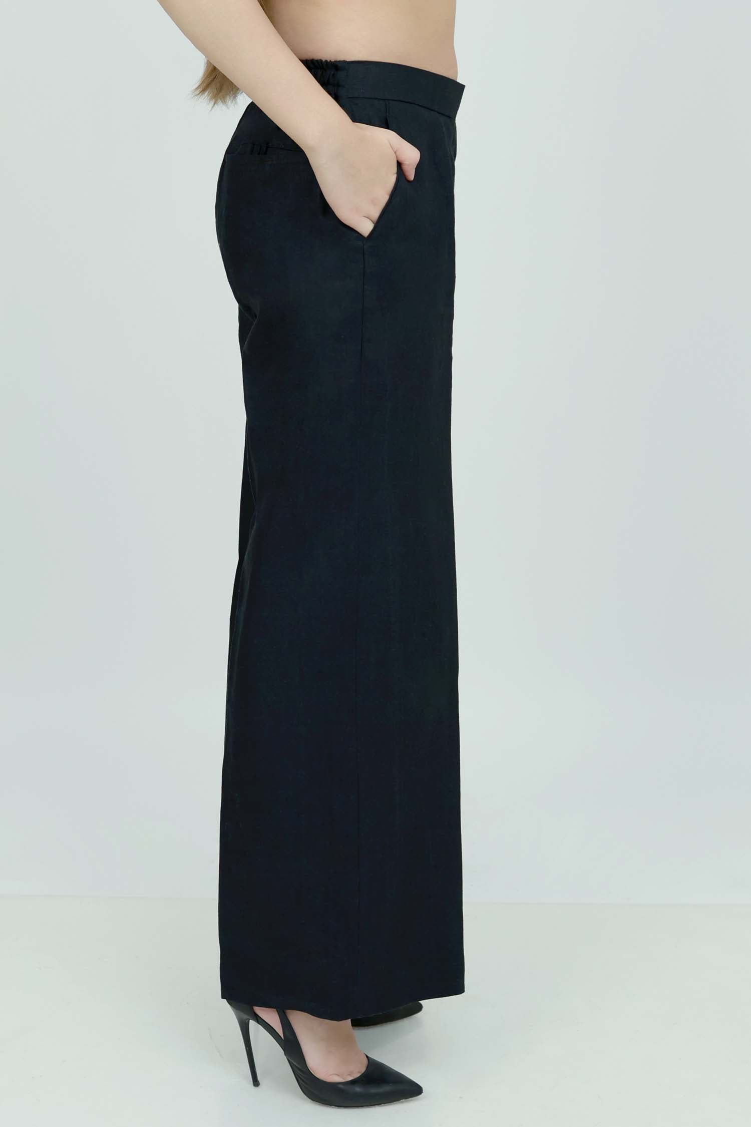A pair of black wide-leg trousers with a mid-rise waist, front buttons, and a relaxed fit. The trousers are fully lined and have a hook and bar closure at the waistband with an adjustable elastic belt.