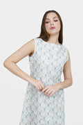 Woman wearing a sleeveless dress with a leaf pattern on a white background