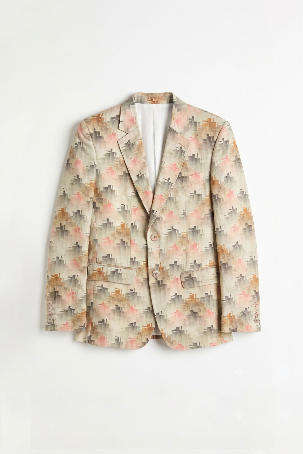 A woman modeling a beige floral linen blazer over a metallic gold midi dress, paired with white sneakers, against a light gray studio background.