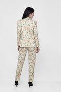Woman wearing a floral suit on a white background