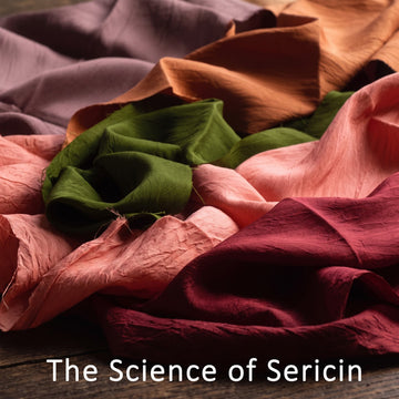 A close-up arrangement of draped, crinkled fabric in multiple colors including mauve, peach, olive green, pink, and burgundy, with the text 'The Science of Sericin' overlaid at the bottom.