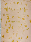 Beige hemp fabric with a scattered pattern of small yellow and olive-green botanical pieces, shown flat with a printed measurement scale on the left edge.