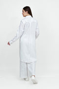 Woman wearing a white shirt and pants on a white background