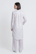 A woman shown from the back wearing a white long-sleeve linen  kurta and matching wide-leg trousers against a plain light gray studio background.