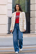 Woman walking outdoors in the Jam hemp boyfriend blazer with a red tee, wide-leg jeans and white sneakers