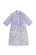A short-sleeved tunic dress with a lavender and white watercolor wash, decorated with an all-over olive green and gold floral print, shown flat on a white background.