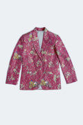 A pink silk blazer jacket featuring an intricate floral and bird pattern in green, yellow, and white, displayed flat against a light gray background.