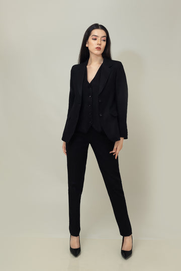 A woman modeling a black linen blazer with a notch lapel, two-button single-breasted design, and flap pockets.