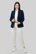 A woman modeling a blue linen blazer with a notch lapel, two-button single-breasted design, and flap pockets.