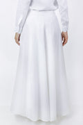Person wearing a white long skirt and light gray top on a white background