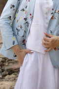 Light blue floral kimono over a white garment with a blurred natural background
