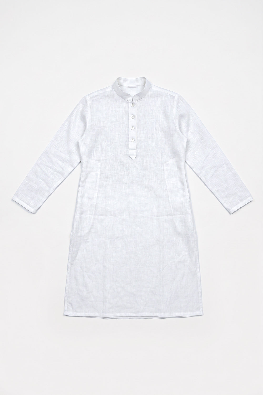 A white long-sleeve linen tunic dress with a buttoned collar and front placket, laid flat against a white background.