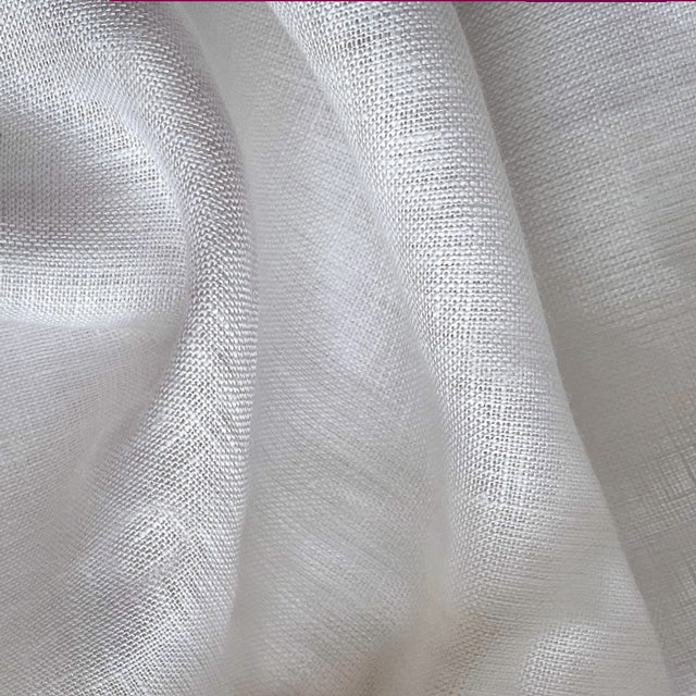 A close-up of draped white fabric with a fine woven texture and soft folds.