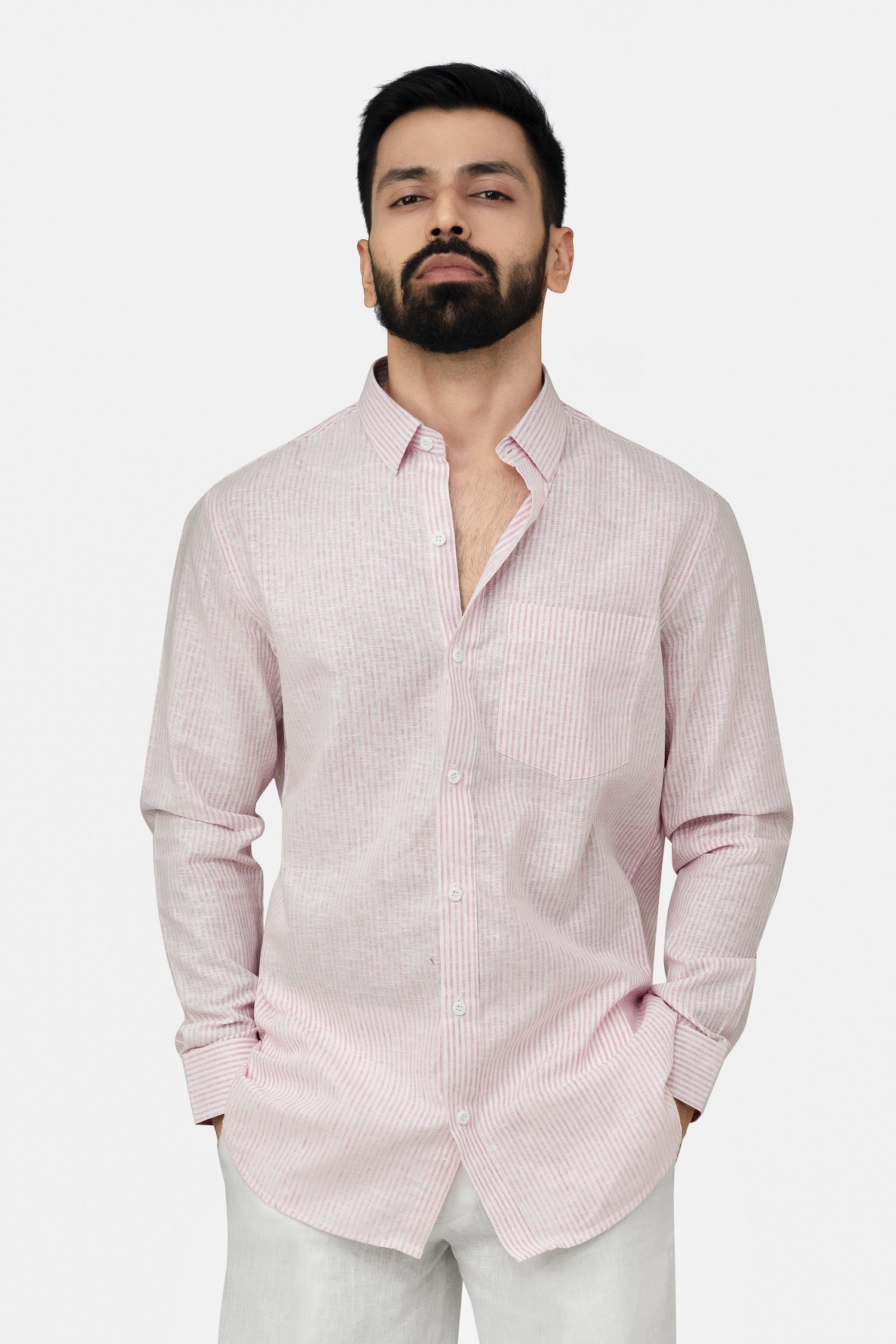 Man wearing a pink shirt against a plain background