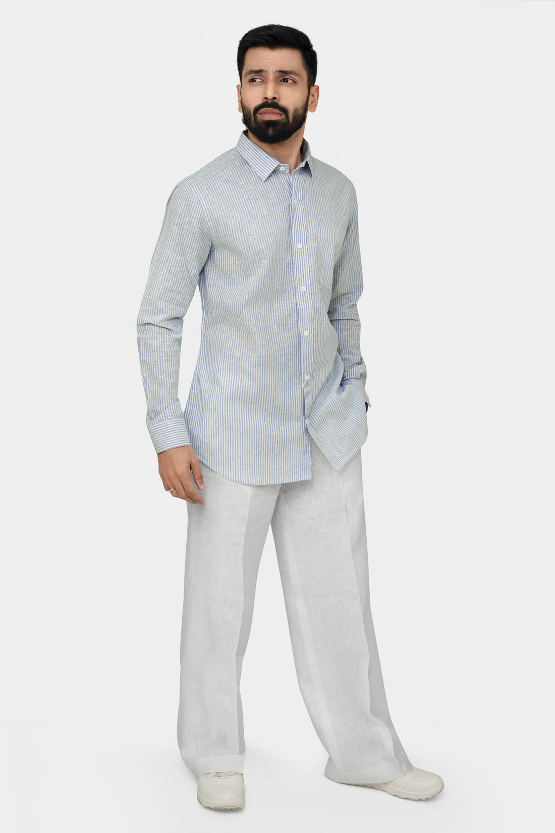 Light blue and white striped shirt on a hanger against a light gray background