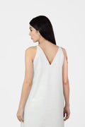 Woman wearing a white sleeveless dress on a white background
