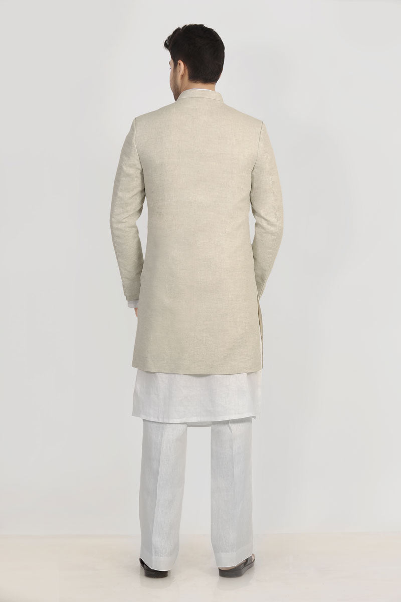 A male model wearing a grey Elm men's linen long coat with a mandarin collar, long sleeves, and front button closures. The coat is fully lined and has a straight fit.