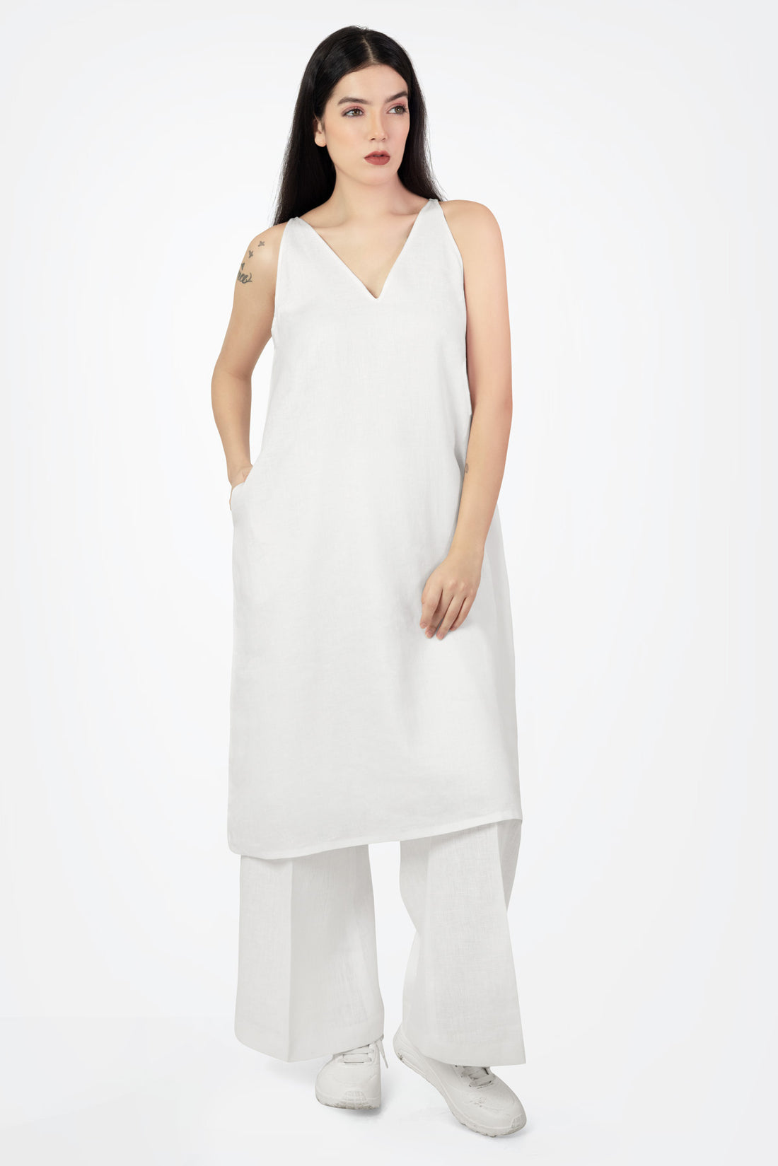 Woman wearing a white sleeveless dress on a white background