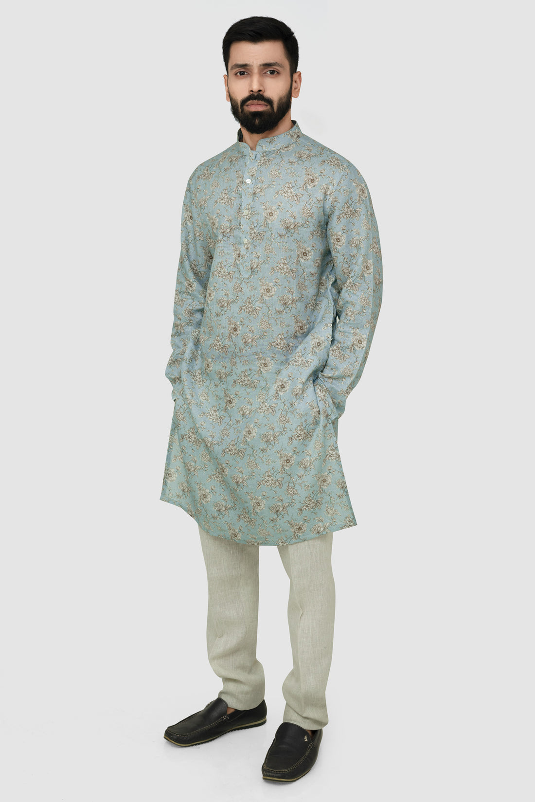 Light blue floral Shirt on a hanger against a light gray background