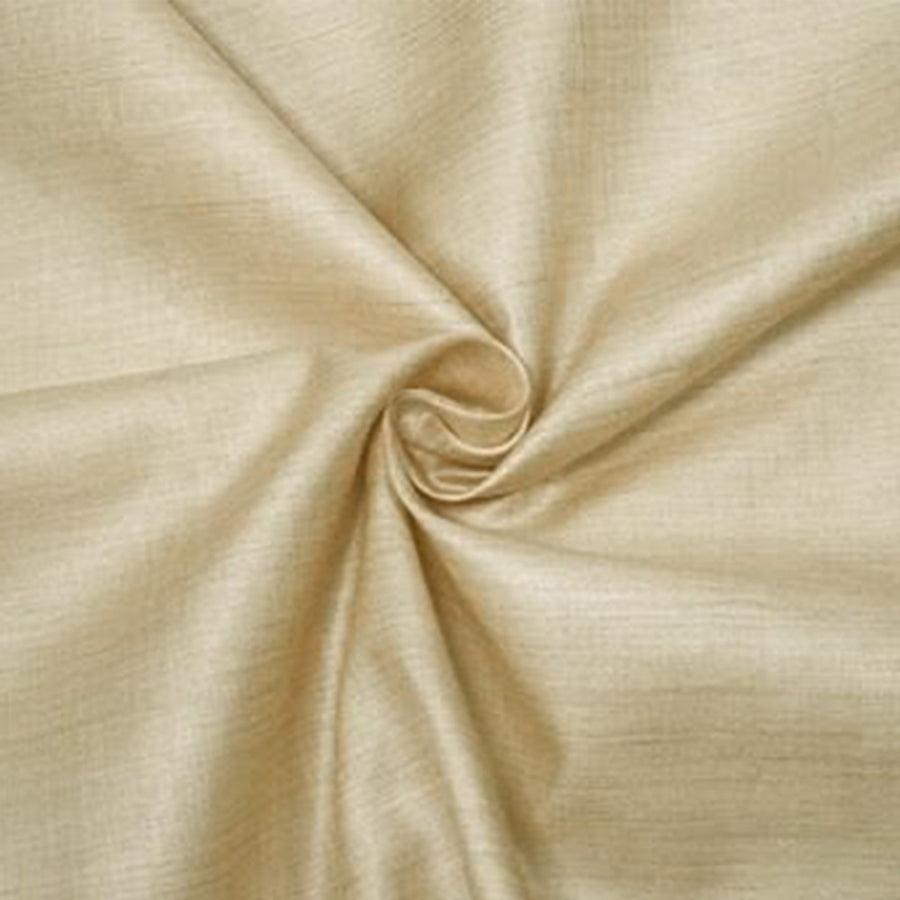 A close-up view of natural golden-beige Muga silk fabric arranged in a soft, elegant central spiral pattern.