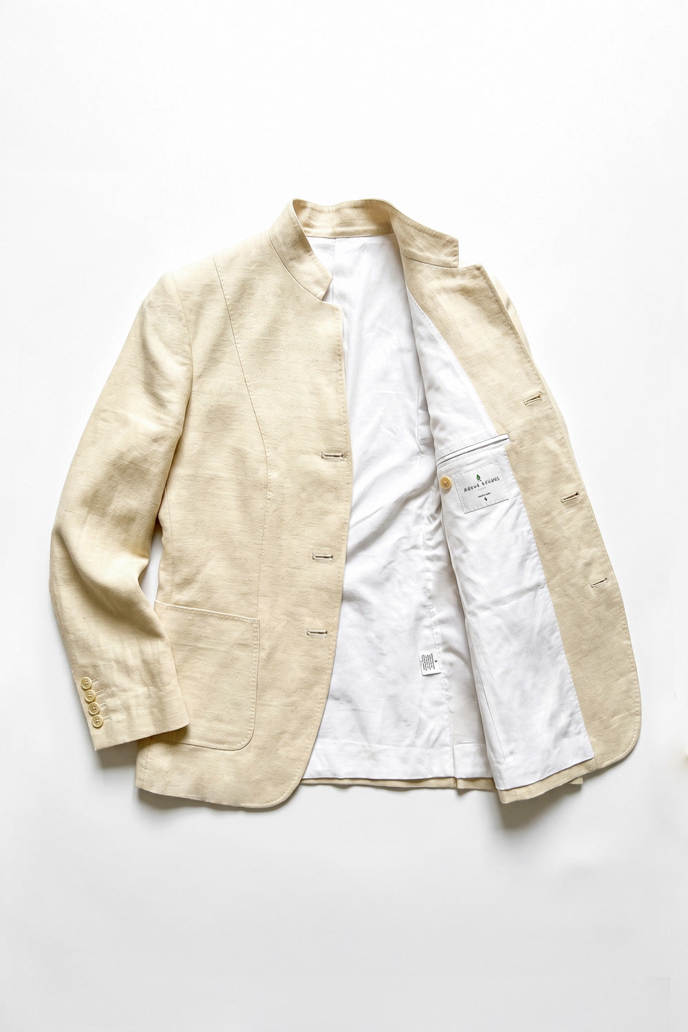 Assam Muga silk jacket laid open to show the cotton satin lining and inner pocket