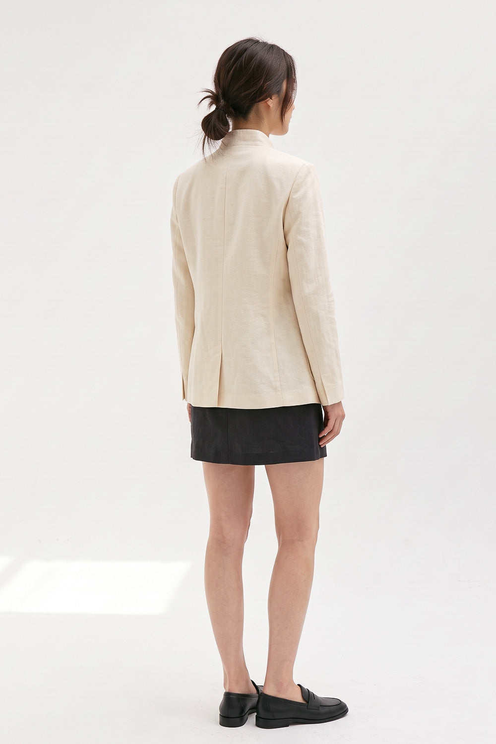 Back view of the Assam Muga silk jacket showing the tailored panels and back vent