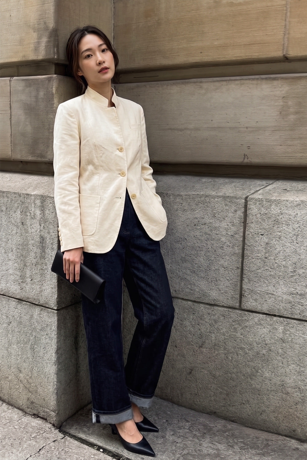 Woman wearing the Assam Muga silk jacket buttoned with dark wide-leg jeans and black flats