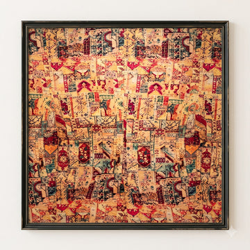 A framed square art print featuring an intricate, dense collage-like pattern in warm beige, red, orange, and teal tones, displayed against a plain white wall.