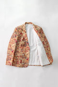 A men's open-front linen blazer jacket featuring a busy, multicolor patchwork print on the exterior and a solid white interior lining, laid flat against a light gray background.