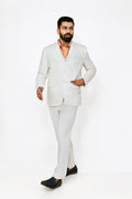A male model wearing a white hemp blazer with a notch lapel, three buttons, two flap pockets and a chest pocket. The blazer is fully lined with a cotton satin interior.