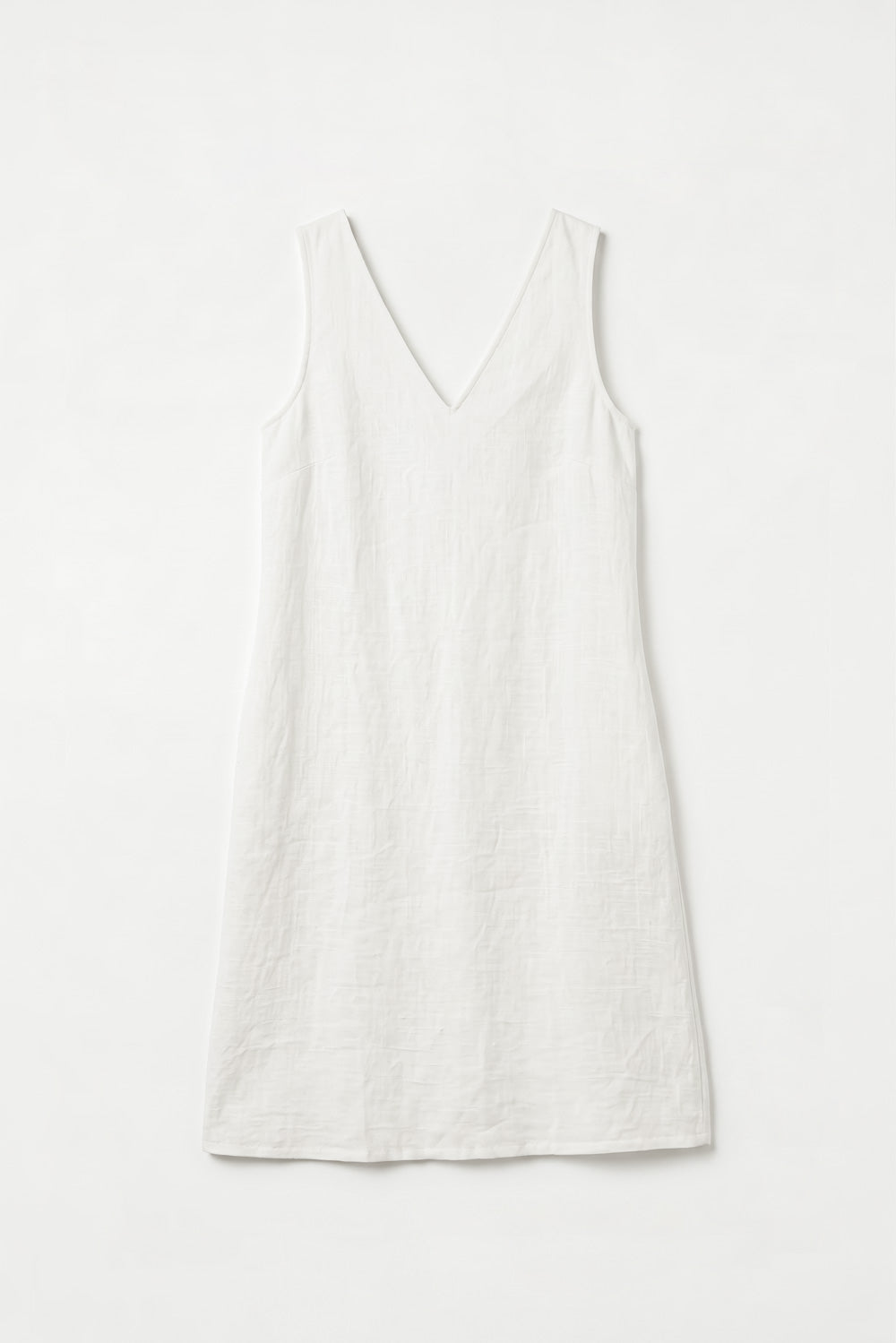 A sleeveless white V-neck hemp dress with a relaxed, slightly loose fit, laid flat against a clean white background.