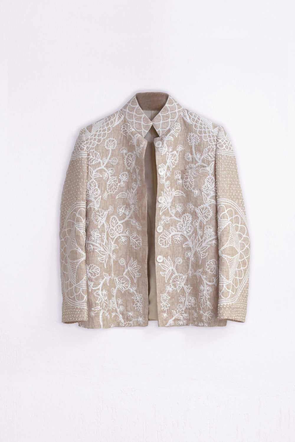 A beige and white embroidered linen blazer-style jacket with a mandarin collar, displayed flat against a plain white background.