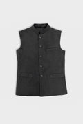 A clean product shot of a black tailored men's linen Nehru jacket/vest featuring a mandarin collar, front button closure, a welt chest pocket, and two lower flapped pockets against a plain light background.