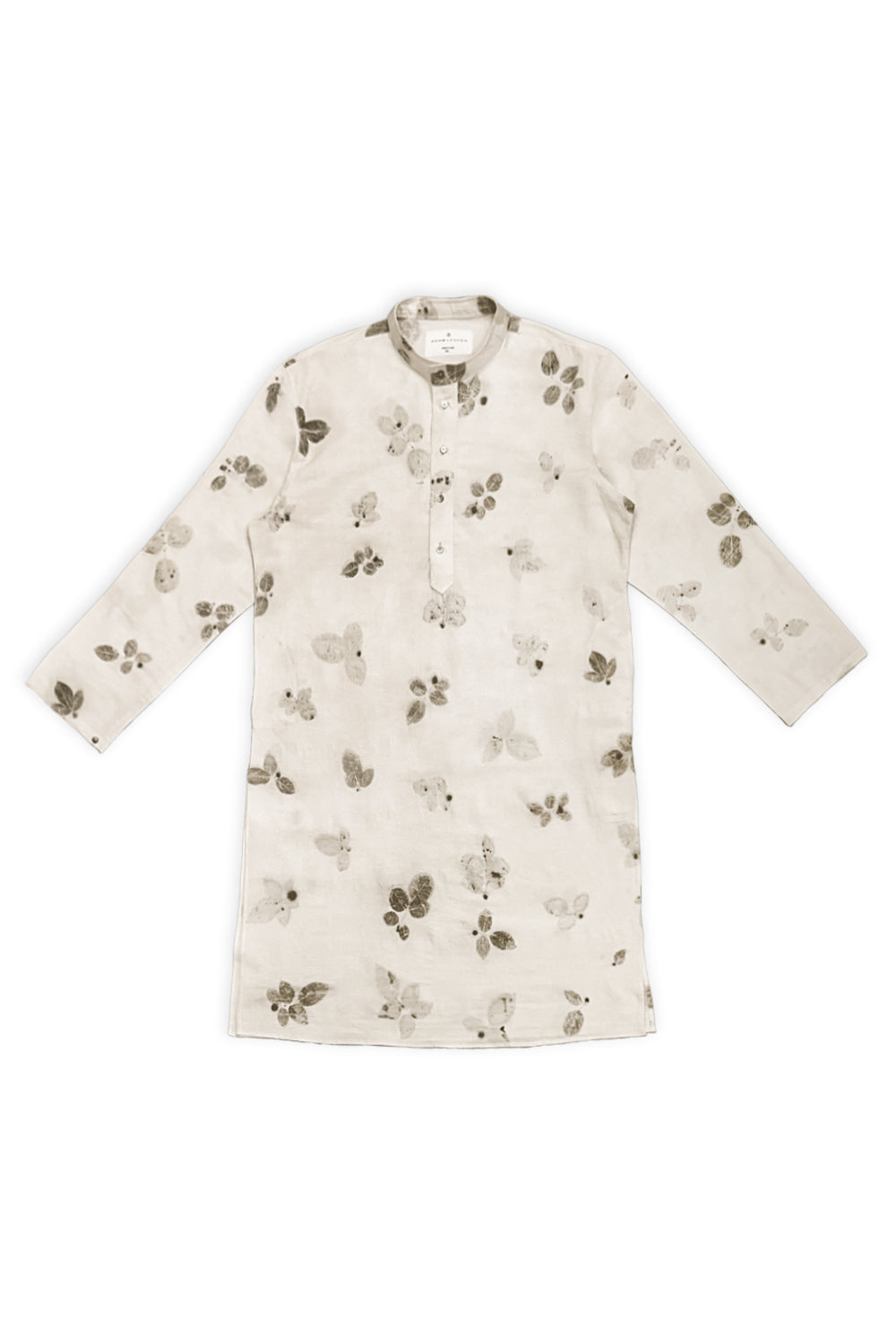 A man modeling a light beige kurta with a dark brown floral print and matching beige trousers, standing against a plain white studio background.